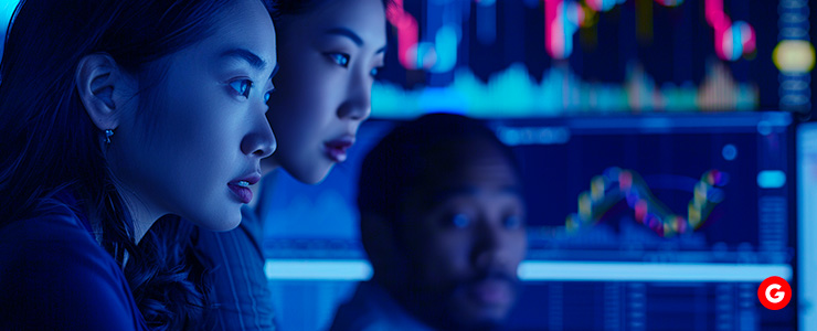 Group of people focused on a computer screen, collaborating and working on a project.