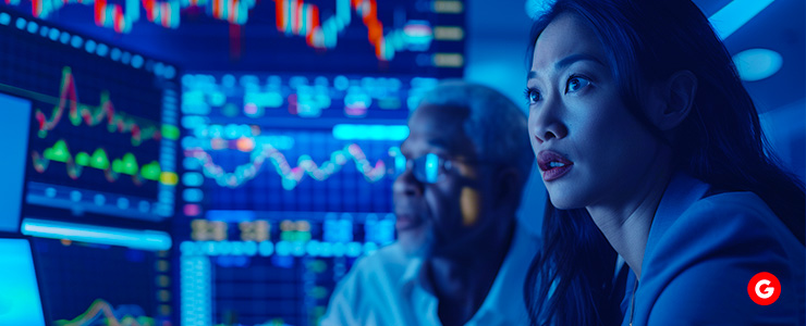 A focused woman examines stock market data on a screen, contemplating investment strategies and market movements.