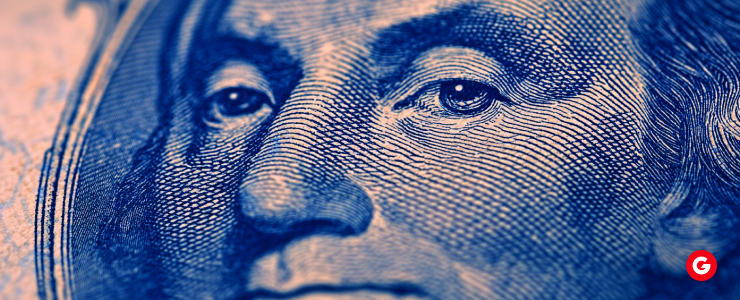 Close-up view of a U.S. dollar bill, highlighting intricate details of the face and design elements.