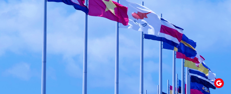 A vibrant display of numerous flags fluttering against a clear blue sky, symbolizing unity and diversity.